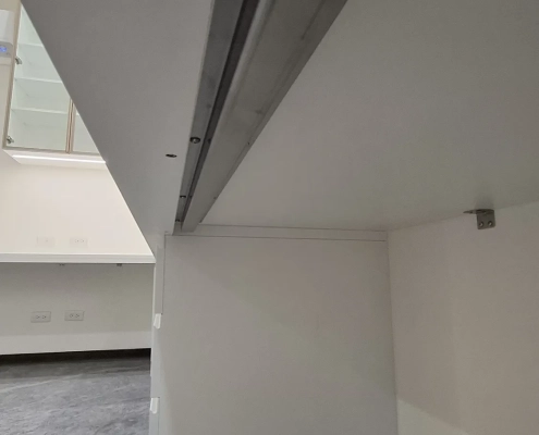 超長 L 型工作桌下方客製不鏽鋼補強結構實拍，提升大跨距承重並防止桌面長期受重下垂變形